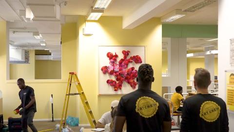 Crew installing artwork on university campus